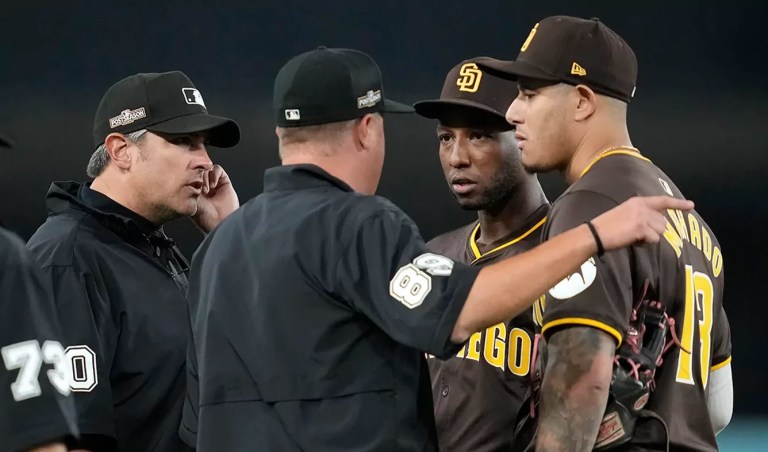 MLB playoff game delayed as crowd throws baseballs and trash at opposing players